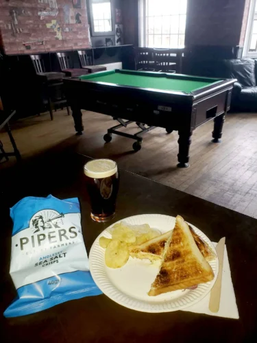 A cheese and ham toastie and the pool table in the gig room at The Three Tuns, Gateshead.